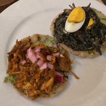 La Chaya Maya - Panucho with cochinita pibil (put smoked pork) on the left, and salbut with relleno negro (pit smoked turkey) on the right - Yucatan Near Me - Mérida, YUC