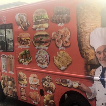 LaGuardia - a chef standing in front of a food truck - Food Trucks Near Me - Queens, New York