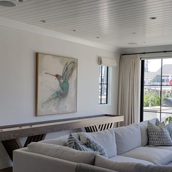 Fashion Interiors - Custom roman shades and white drapery on rod and rings. living room - Shades & Blinds Near Me - Manhattan Beach, California Fashion Interiors - Custom roman shades and white drapery on rod and rings. living room - Shades & Blinds Near Me - Manhattan Beach, California