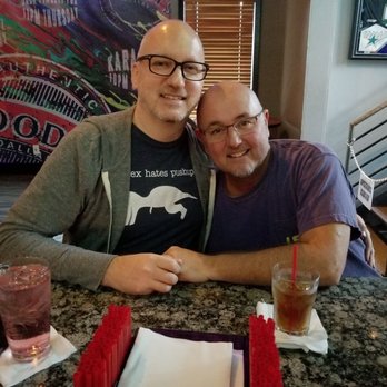 Woody's - a man and a woman sitting at a table - Gay Bars Near Me - Dallas, Texas Woody's - a man and a woman sitting at a table - Gay Bars Near Me - Dallas, Texas