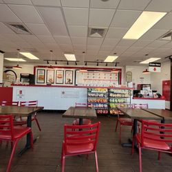 Empty counter. All five (5) staff in back eating chips and food.