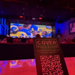 Cover Sports & Shows - The QR code to review the menu and the giant screen in the background.