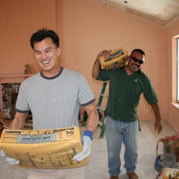 two men working on a house two men working on a house