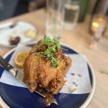 Lingo - a plate of food on a table - New American Near Me - Brooklyn, New York