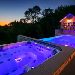 Paradise Decks & Spas - Swim Spa and Hot Tub Combination at night