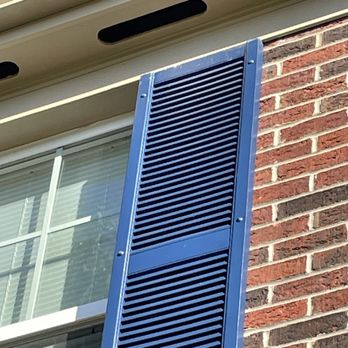 JMartini Painting & Renovations - a window with blue shutters - Painters Near Me
