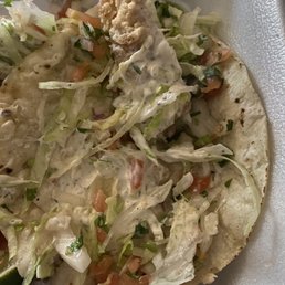 Fish taco with a small piece of a fish.