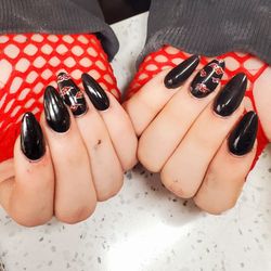 Natalie’s Nails & Salon - Acrylic nails with Akatsuki Clouds painted on the ring finger.