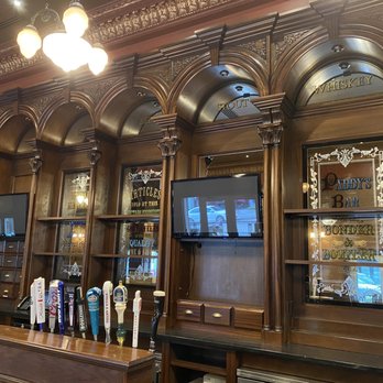 KC Hooley House - a bar with wooden walls and a television - Irish Pub Near Me - Kansas City, Missouri KC Hooley House - a bar with wooden walls and a television - Irish Pub Near Me - Kansas City, Missouri