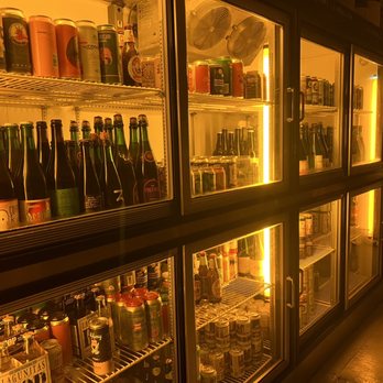 Covenhoven - a row of beer bottles in a refrigerator - Beer Bar Near Me - Brooklyn, New York Covenhoven - a row of beer bottles in a refrigerator - Beer Bar Near Me - Brooklyn, New York