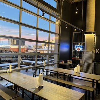 Smok Barbecue - tables and benches in front of a large window - Barbeque Near Me - Denver, Colorado