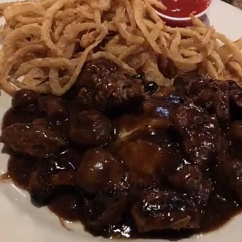 Robert's Steakhouse - Beef tips and French fried onions with mash potatoes underneath - Steakhouses Near Me - Flatonia, Texas Robert's Steakhouse - Beef tips and French fried onions with mash potatoes underneath - Steakhouses Near Me - Flatonia, Texas
