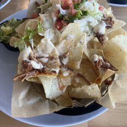 Nachos with a lot of tasty chips and little queso. Nachos with a lot of tasty chips and little queso.
