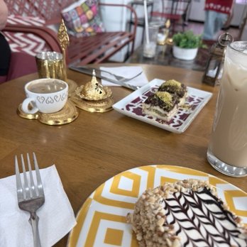 Turkish Coffee Lady - Traditional coffee in the gold service, our two types of desserts, and my iced latte. - Coffee & Tea Near Me - Alexandria, Virginia Turkish Coffee Lady - Traditional coffee in the gold service, our two types of desserts, and my iced latte. - Coffee & Tea Near Me - Alexandria, Virginia