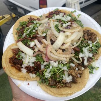 Taco El Yogy - a person holding a plate of tacos - Food Trucks Near Me - Santa Ana, California Taco El Yogy - a person holding a plate of tacos - Food Trucks Near Me - Santa Ana, California
