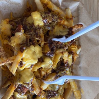 Johnny Rockets - a plate of cheese fries with chopsticks - Burgers Near Me - South Padre Island, Texas
