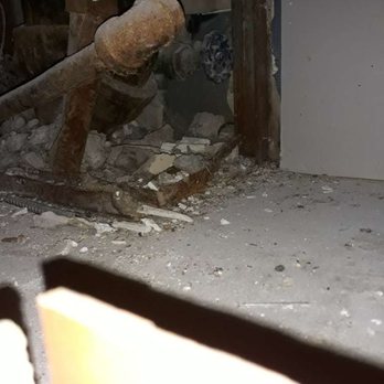 Barrett & Stokely - View of old pipes from hole in the kitchen. - Property Management Near Me - Indianapolis, Indiana Barrett & Stokely - View of old pipes from hole in the kitchen. - Property Management Near Me - Indianapolis, Indiana