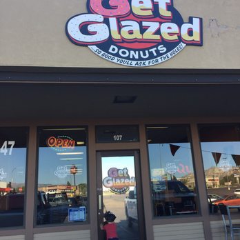 Get Glazed - a child standing in front of a donut shop - Donuts Near Me - Vernal, Utah