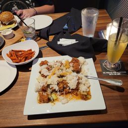 Sweet potato fries, orange chicken, and Pina spritz.