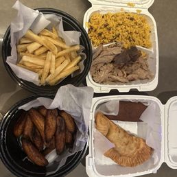 Yucca frita, lechon with arroz con condules, platanos, beef empanada, alcapurria