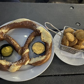 The Trestle - Jumbo pretzel - served cold w cold cheese. Not good  Fried Pickle Chips were better - Cocktail Bars Near Me - Astoria, New York
