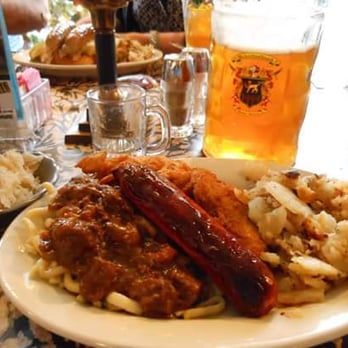 Schnitzelbank - German Sample Platter - Goulash on Spaetzel, Knockwurst, Weinerschnitzel, German potatoes, hot sauerkraut and a giant beer - American Near Me - Jasper, Indiana