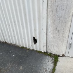 M Gray Property Inspections - Asbestos siding damaged around building needs to be replaced and remediated