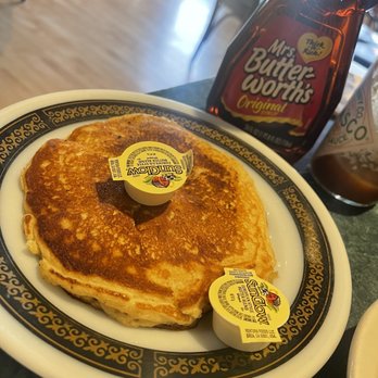 Hatchery Restaurant & Lounge - a stack of pancakes on a plate - American Near Me - Orange City, Iowa