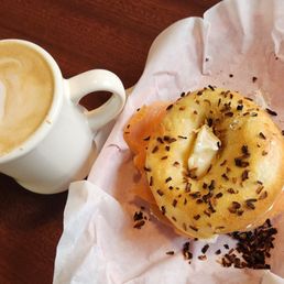 Latte and onion bagel with cream cheese and lox.