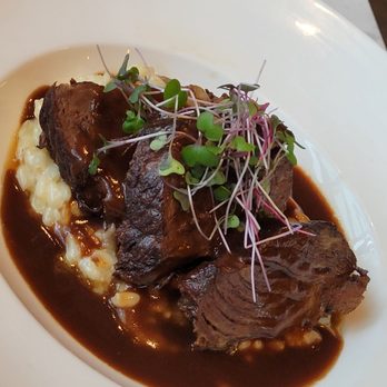 Skybox Taphouse - Braised beef served over a bed of mushroom risotto - Pizza Near Me - Honolulu, Hawaii Skybox Taphouse - Braised beef served over a bed of mushroom risotto - Pizza Near Me - Honolulu, Hawaii