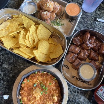 Topgolf - Buffalo dip, macaroni cheese balls, warm soft pretzel bites. Partially pictured: a delicious pitcher of mango cart - Sports Bars Near Me - Ontario, California Topgolf - Buffalo dip, macaroni cheese balls, warm soft pretzel bites. Partially pictured: a delicious pitcher of mango cart - Sports Bars Near Me - Ontario, California
