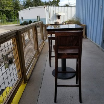 Pawley's Island Brewing - a table and chairs on a patio - Breweries Near Me - North Charleston, South Carolina Pawley's Island Brewing - a table and chairs on a patio - Breweries Near Me - North Charleston, South Carolina