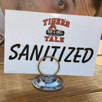 The Tiger's Tale - a man holding a sign - Bars Near Me - Skillman, New Jersey