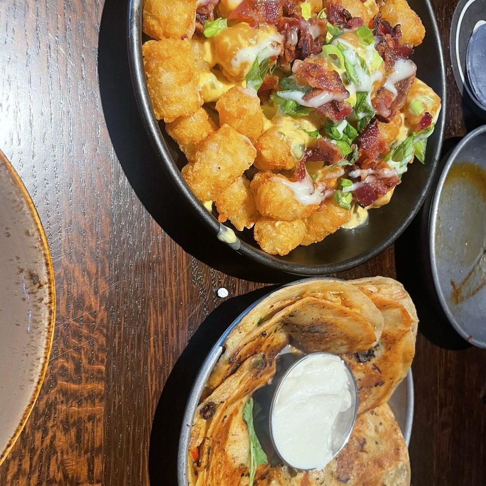 Puttshack - Dania Beach - Loaded tots and Southwest chicken quesadillas - Mini Golf Near Me - Dania Beach, Florida Puttshack - Dania Beach - Loaded tots and Southwest chicken quesadillas - Mini Golf Near Me - Dania Beach, Florida