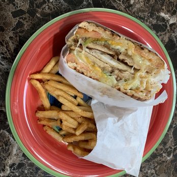 Spreads Bagels and Cafe - Whole Wheat Grilled Cheese Panini with cucumbers, tomato, lettuce, and fried onions with fries - Bagels Near Me - Southfield, Michigan