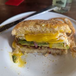Breakfast sandwich with bacon and avocado.