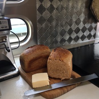 Fry's Red Wheat Bread - a loaf of bread and butter on a cutting board - Bakeries Near Me - Victoria, British Columbia
