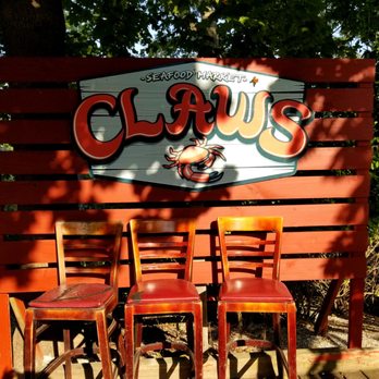Claws - a row of chairs in front of a sign - Seafood Near Me - West Sayville, New York Claws - a row of chairs in front of a sign - Seafood Near Me - West Sayville, New York