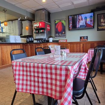 Capri's Pizzeria - Interior, small dining room with four tables. Two tables outside. - Pizza Near Me - Bethel, Connecticut Capri's Pizzeria - Interior, small dining room with four tables. Two tables outside. - Pizza Near Me - Bethel, Connecticut