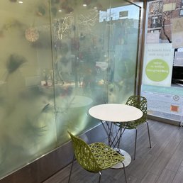 a table and two chairs in front of a glass wall