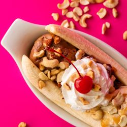 Snelgrove Ice Cream - Nutty Banana Split: Burnt Almond Fudge, Rocky Road, and Caramel Cashew topped with hot caramel drizzle, almonds and cashews!