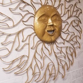 La Cocina - a gold sun face on a wall - Mexican Near Me - Chicago, Illinois