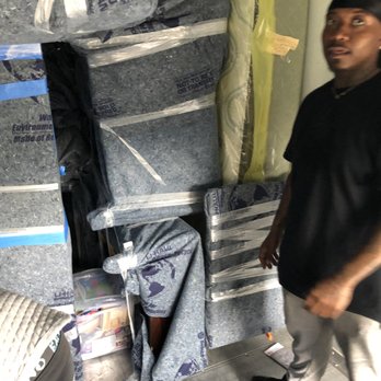 J Sutton & Co Moving Services - J Sutton & Co. Mover's Avery and Dre team up to wrap, pack and load furniture on the rental truck. - Movers Near Me - Bronx, New York