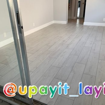 Upayit iLayit - a view of a living room through a sliding glass door - Flooring Near Me Upayit iLayit - a view of a living room through a sliding glass door - Flooring Near Me