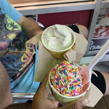 Carvel - a person holding a cup of ice cream and a cup of sprinkles - Ice Cream & Frozen Yogurt Near Me - Sunrise, Florida