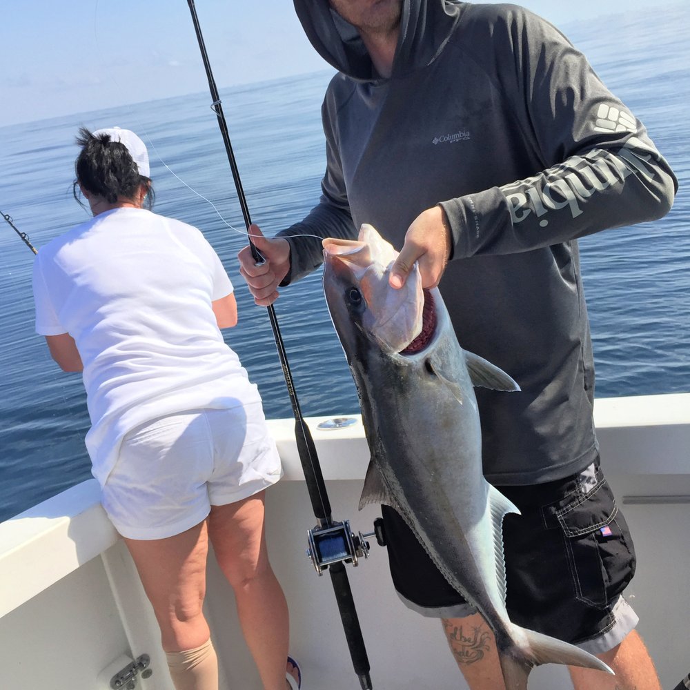 Captain Blacks Fishing - My husband showing off an Amberjack fish. - Fishing Near Me - Panama City, Florida