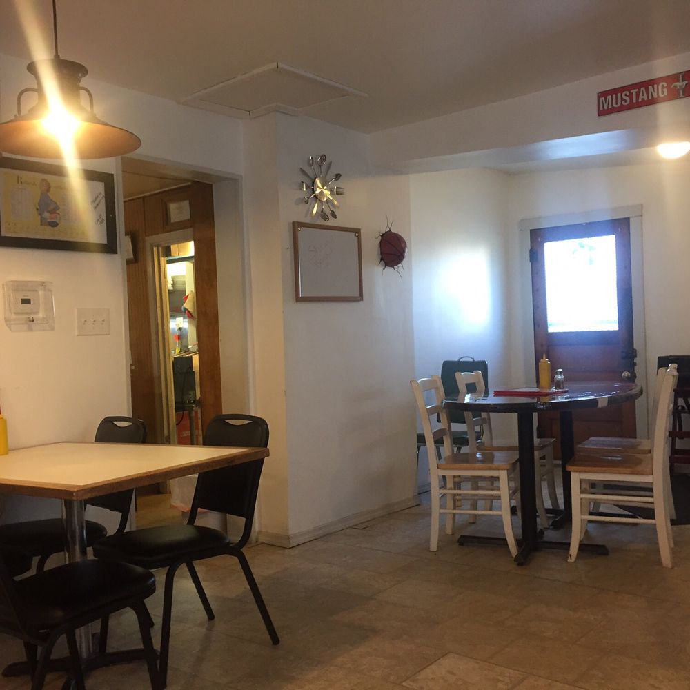 Edna's Place - a dining area with a table and chairs - American Near Me - Macksville, Kansas