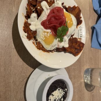 The Cottage - Chilaquiles.  Black beans come on the side and the potatoes are at the bottom of the chilaquiles - New American Near Me - Encinitas, California