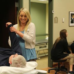 Chautauqua Physical & Occupational Therapy - Emily Ford, PTA stretches Margaret Miller's shoulder.