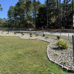 Hillside Landscape Supplies - Flowerbed covered in New England River Rocks.
